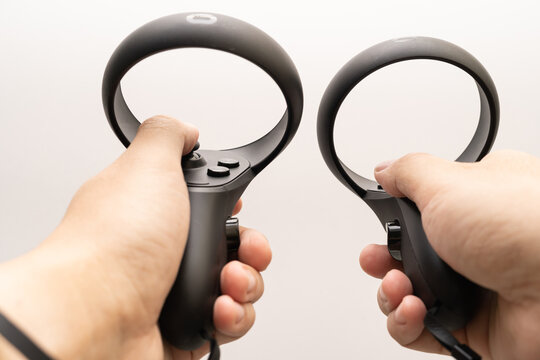 oculus rift touch controller on hand isolated on white background. Oculus Quest 2 virtual reality headset controllers. 