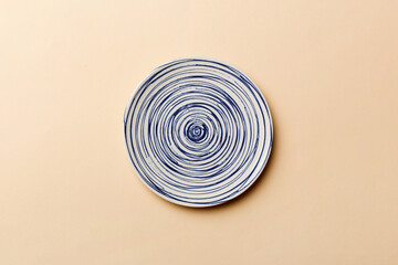 Fototapeta na wymiar Top view of isolated of colored background empty round blue plate for food. Empty dish with space for your design