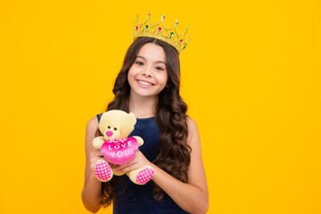Fototapeta na wymiar Birthday kids prom party. Teenage girl with crown, feeling princess, confidence. Child princess crown on isolated studio background. Happy girl face, positive and smiling emotions.