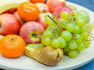 fruits plate with fresh grapes, pears, apples