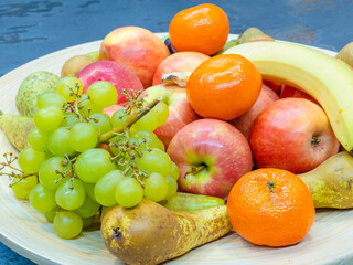 fruits plate with fresh grapes, pears, apples