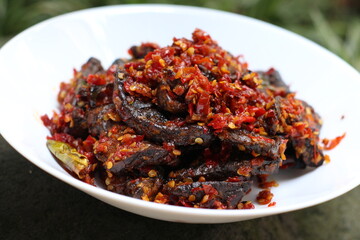 A plate of Fried Cow Lungs Spicy, commonly called in Indonesia 'Paru Goreng Balado', Indonesian...