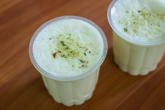 Sweet lassi a traditional Indian savory cold drink and green salad Manali Jaipur, India. blend of yogurt, cream, water, spices and sometimes fruits. Refreshing summer drink.