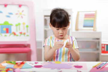 Obraz na płótnie Canvas young girl making paper craft for homeschooling