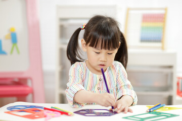 young girl practice drawing different shapes  for homeschooling