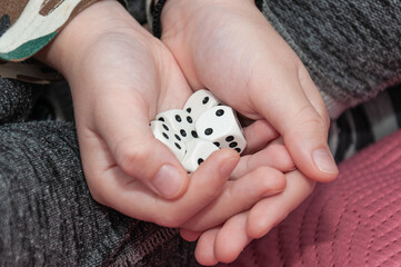 A set of dice in the hands of a child.