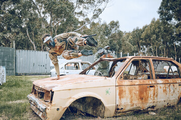 Car, jump or man in a paintball shooting game playing with speed or fast action on a fun...