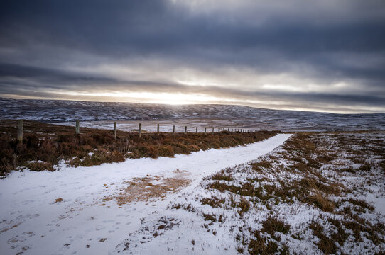 The frozen snow covered landscape, countryside of Buckshott moor with distant views of Muggleswick and Edmondbyers in winter near Blanchland, Northumberland  in England UK.