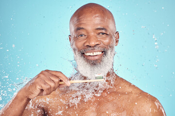 Fototapeta na wymiar Water splash, toothbrush and portrait of black man with smile on face, mockup isolated on blue background. Teeth, toothpaste and product placement, senior dental care and cleaning mouth in studio