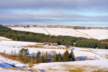 Traditional farm buildings on the snow covered moors, countryside of Boltshope in winter near Blanchland, Northumberland  in England UK.