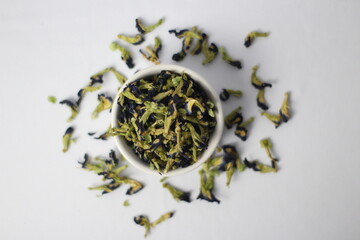 a bowl of dried Butterfly flower surrounded by other dried Butterfly flower, Top View, Selective focus.