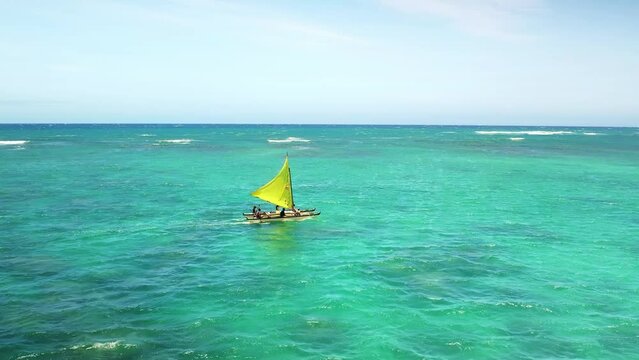 Drone Hawaii. Hawaiian outrigger canoe, traditional boat tour. Kailua Bay lagoon, Kailua beach. Popular tourism destination on Oahu, tropical island. Island culture and traditions. 