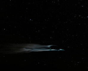 Fast UFO moving across a night sky