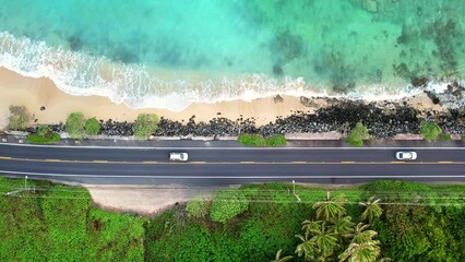 Drone Hawaii. Aerial view coastal road by Kualoa mountains, Oahu windward side. 