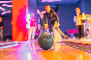 Bowling provides a fun and relaxed atmosphere for players looking to unwind and bond with loved ones, from amateurs to professionals, bowling attracts players of all skill levels - obrazy, fototapety, plakaty