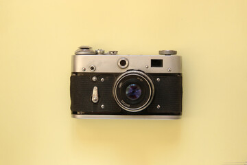 Beautiful vintage camera on a yellow background.