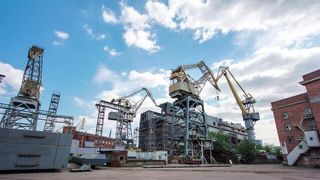 The construction of a large ship on a shipyard with cranes timelapse hyperlapse. A fragment of the case in the workshop of the plant. Metal frame during assembly