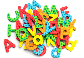 Top view of colorful magnetic alphabet letters for children learning to write. Colored ABC on white background. Playing with words.