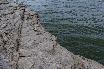 rocks on the shore of the lake, river. Surf on a rocky shore. Lake Bakota Reservoir, Dniester River, Podilski tovtry National park, Khmelnitskiy region of Western Ukraine