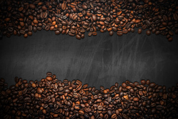 Large group of roasted coffee beans on an empty blackboard with copy space. Horizontal composition.