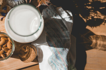 Milk and nuts, two staples of a balanced diet, arranged beautifully and ready to be combined into a healthy meal