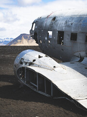 In the wilds of Iceland, a forgotten plane rots away in the desert, dwarfed by the towering peaks of the surrounding mountains