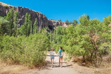 Tourists girls exploring and walking at popular travel attraction of Turkey and Cappadocia - Ihlara valley