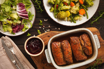 Roasted duck breasts served with vegetables and cranberry dip.