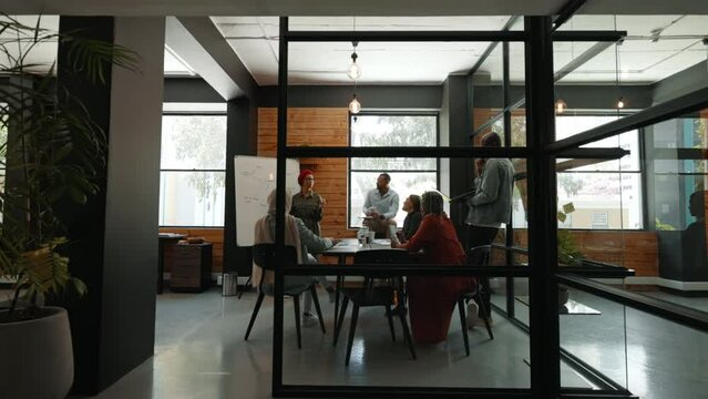 Multicultural business professionals collaborating on a project in a coworking office. Group of creative business people having a discussion and brainstorming ideas and solutions in a meeting.