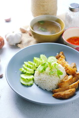Thai style grilled chicken with rice and spicy soup on white background