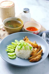 Thai style grilled chicken with rice and spicy soup on white background