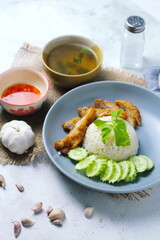 Thai style grilled chicken with rice and spicy soup on white background