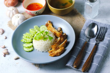 Thai style grilled chicken with rice and spicy soup on white background