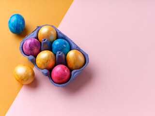 Flat lay with colored easter eggs on bright background. Creative template for festive content