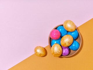 Creative layout with colored easter eggs on bright background. A template for festive content