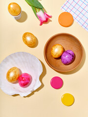 Creative layout with colored easter eggs on bright background. A template for festive content