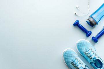 Sport fitness flatlay with sneakers and dumbbells, top view