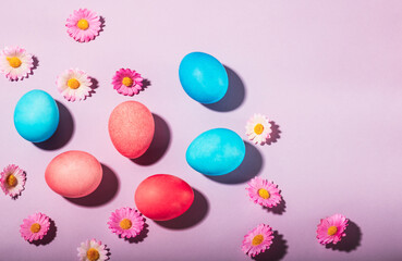 Fototapeta na wymiar Painted Easter eggs on a lavender background.