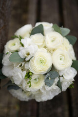 Wedding bouquet of white flowers - ranunculus, freesia, lisianthus.. Wedding. Bride and groom.