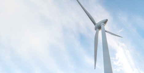 blurred banner windmill farm or wind park, with high wind turbines for generation electricity. Green energy generating concept. Sustainable development, renewable energy, winter, copy space