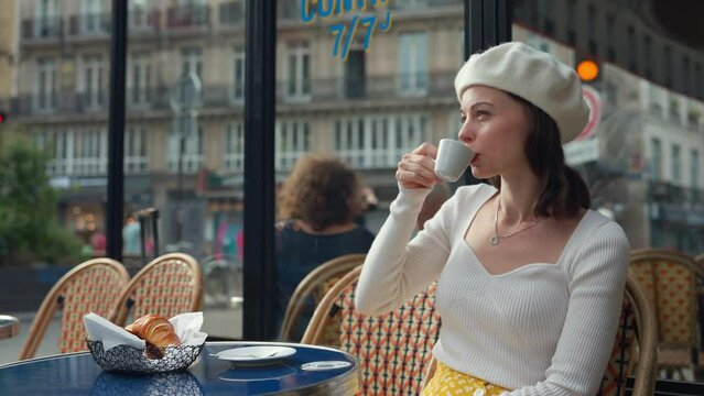 Pretty girl with coffee in a bistro near the road
