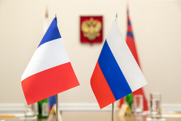 Flags of cooperation between Russia and France. Close-up at the negotiating table.