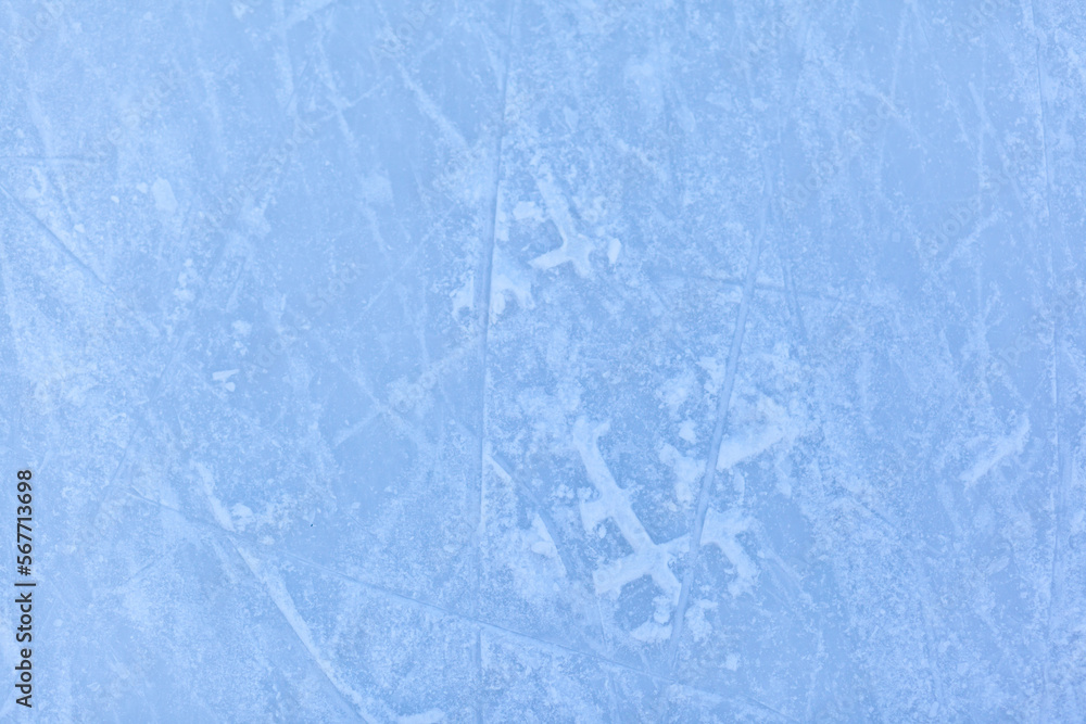 Poster empty ice rink with skate marks after the session outdoor. skating ice rink texture covered with sno