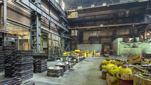 The liquid metal is poured into molds at the metallurgical plant timelapse hyperlapse. Worker controlling metal melting in furnaces. Factory workshop with steelmaking furnace