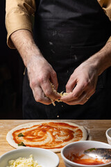 the chef prepares delicious pizza in the restaurant. Close-up
