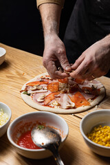 the chef prepares delicious pizza in the restaurant. Close-up
