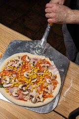 the chef prepares delicious pizza in the restaurant. Close-up
