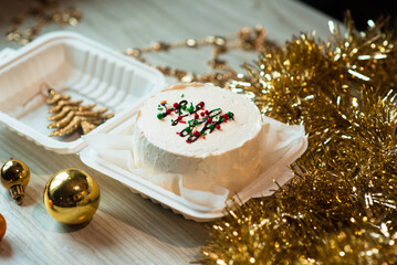 small white bento cake with christmas tree decor in the table. Christmas mood. photo for confectioner content
