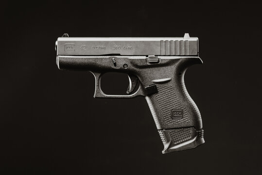 Brno, CZE - 8 24 2022: The Glock 42 is one smallest Glock pistol in caliber 380. Side view. Dark black background.