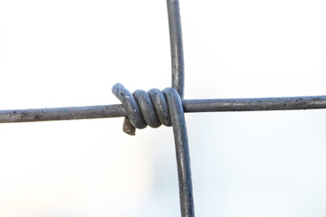 Steel wire fence from the grid with silver polymer coating. Tensile Mesh knotted wire mesh...